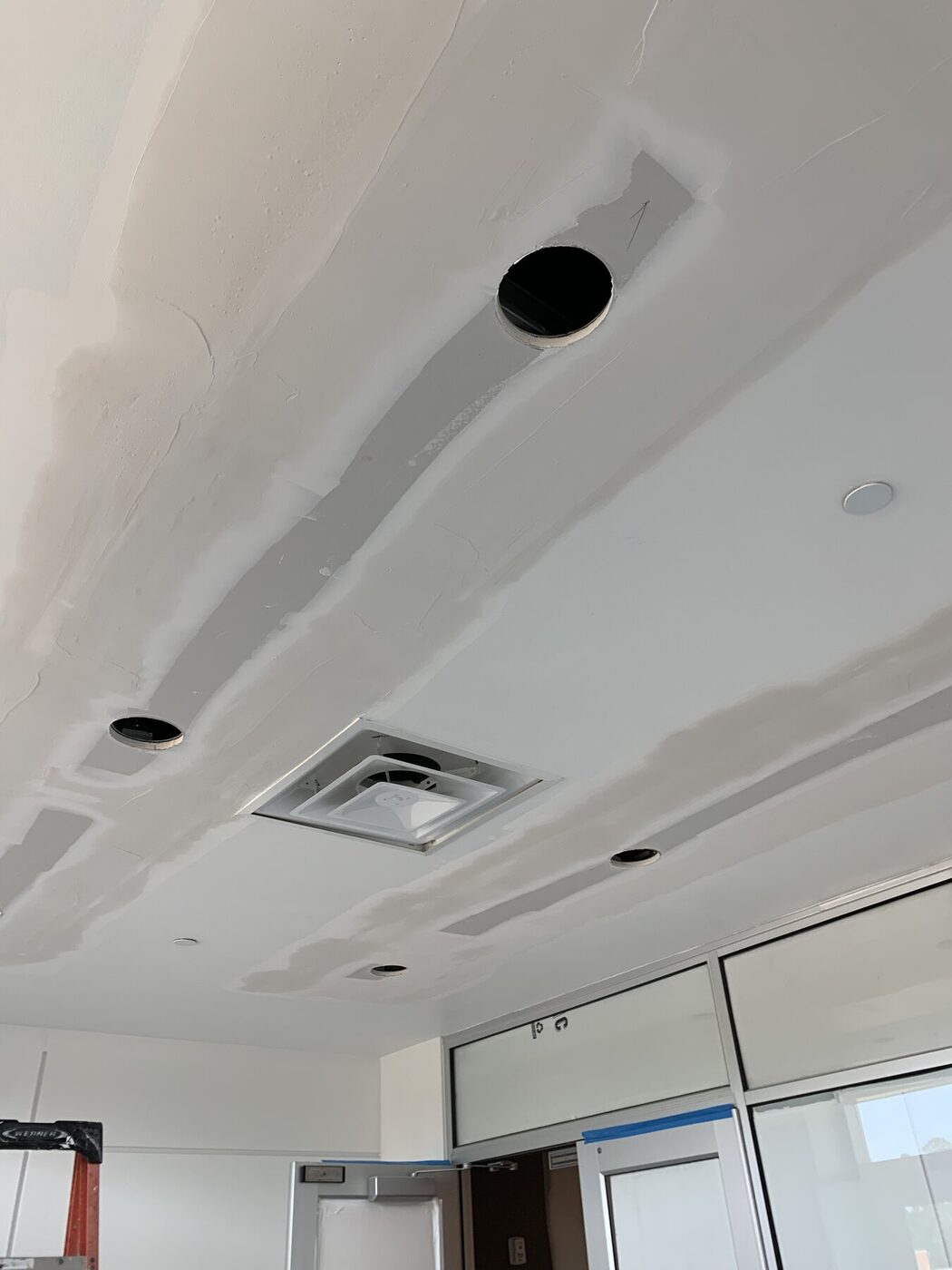 Commercial ceiling drywall finishing around recessed fixtures and air distribution